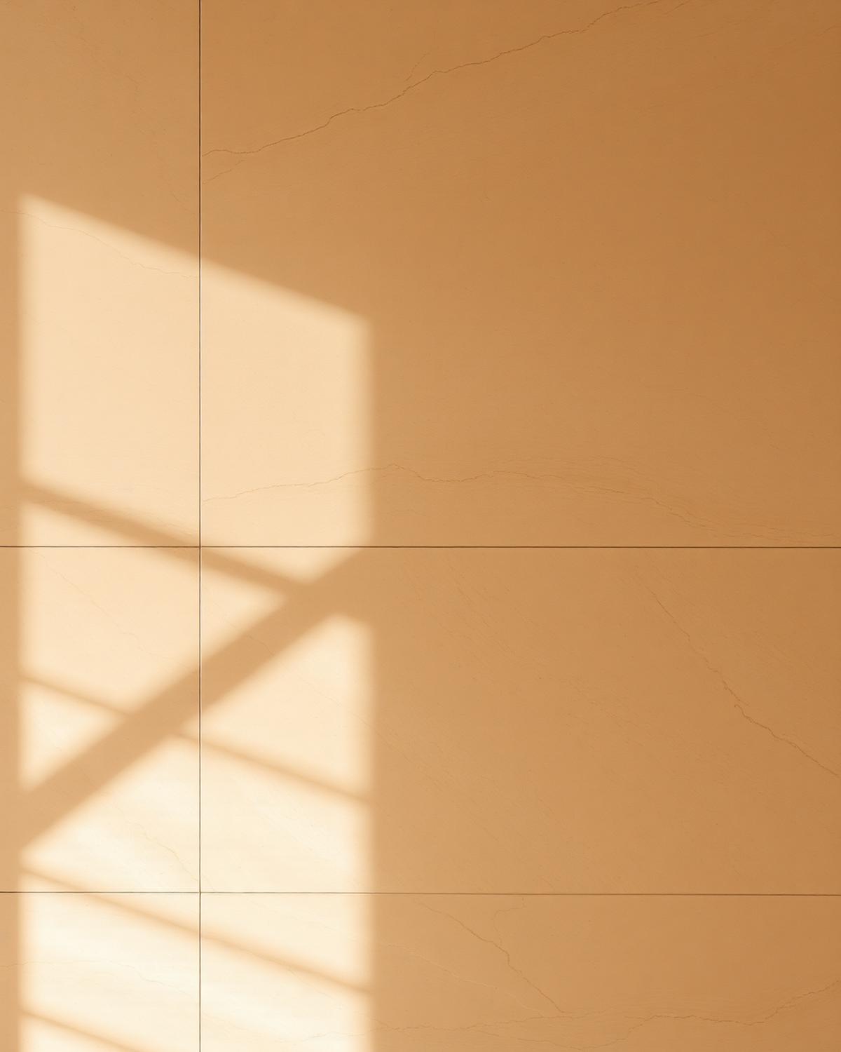 Warm travertine wall with soft window light